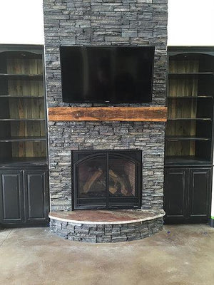 Simple reclaimed wood mantle over fireplace